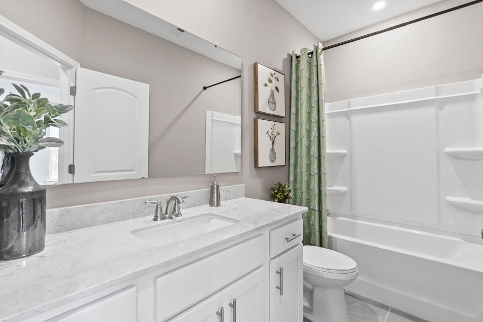 A bathroom with a sink toilet and a bathtub.