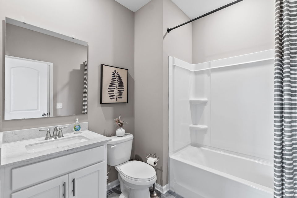 A bathroom with a tub toilet and sink.