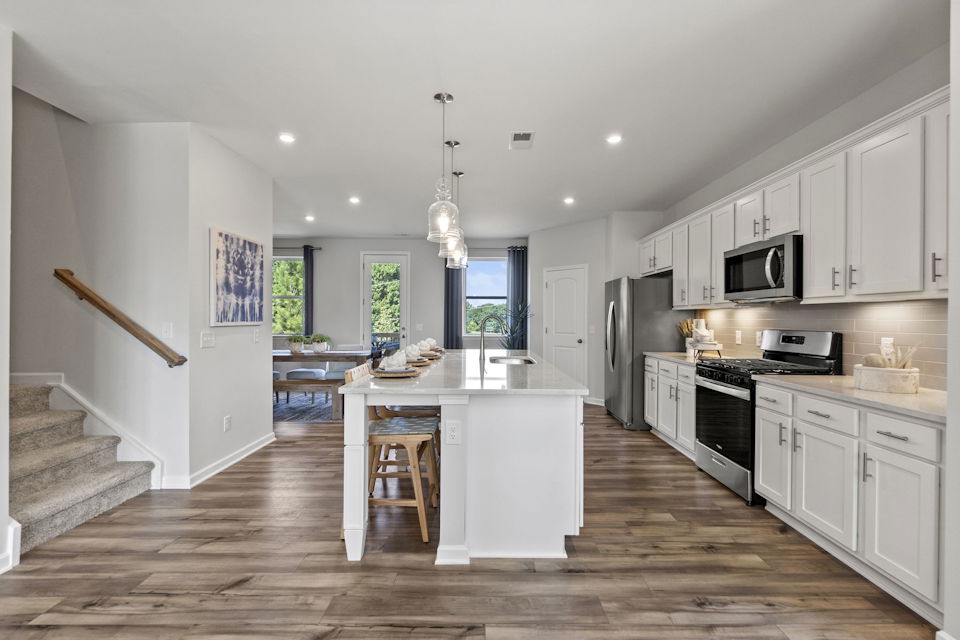 A kitchen with white cabinets.