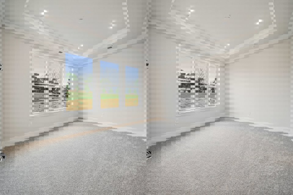 A room with a window and a carpet.