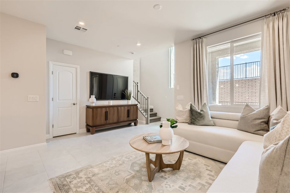 A living room with a tv and couches.
