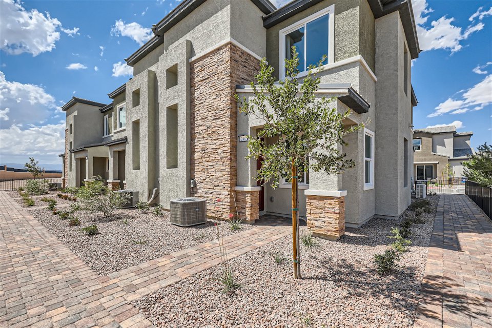 A brick building with a tree in front of it.