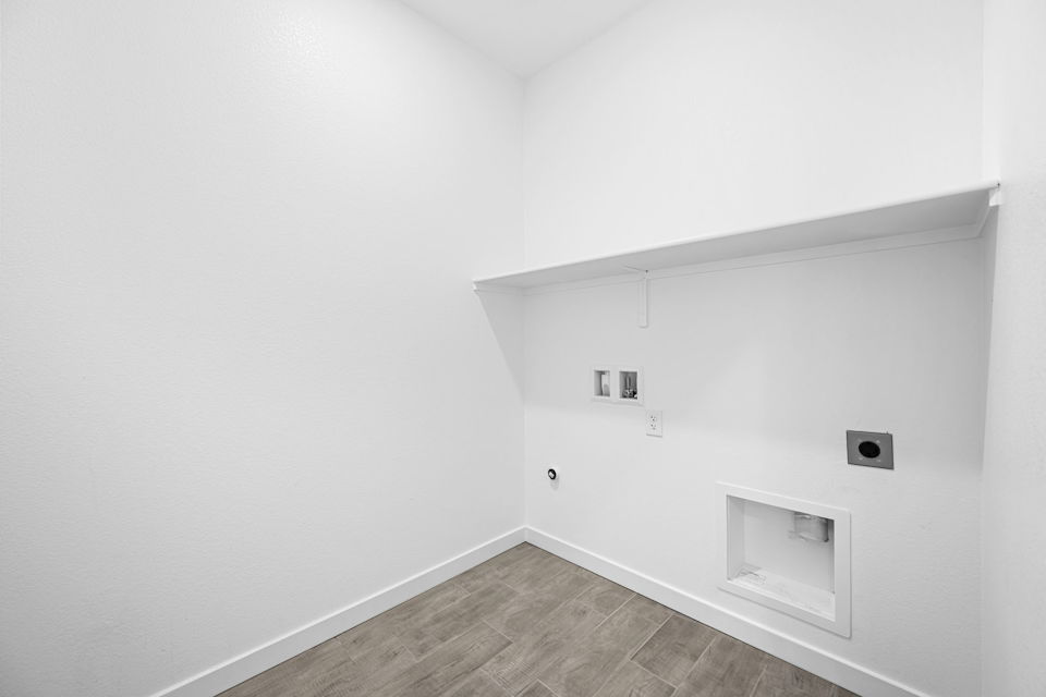 A white room with a wood floor.