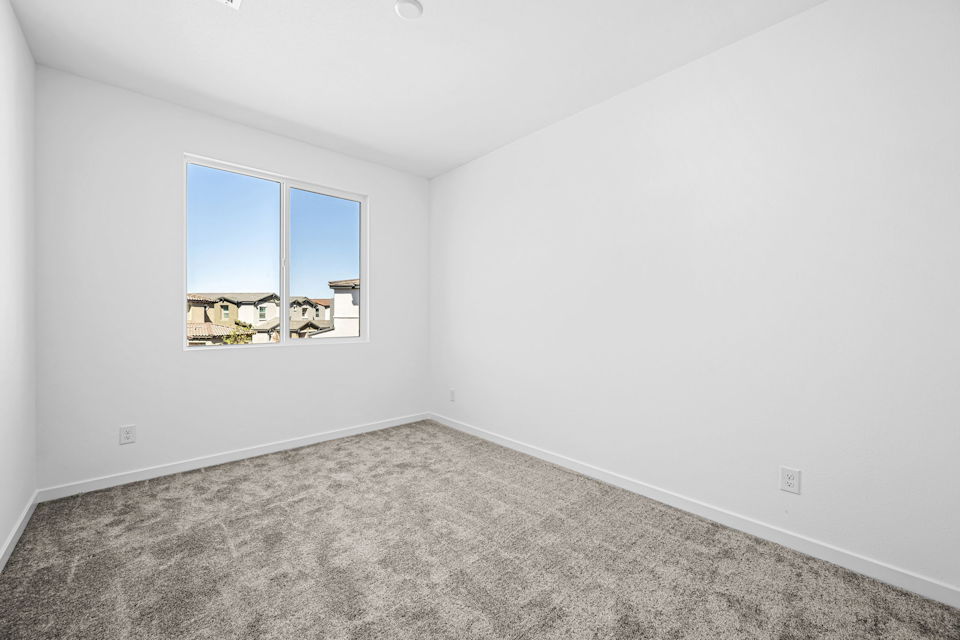 A room with a window and a carpet.