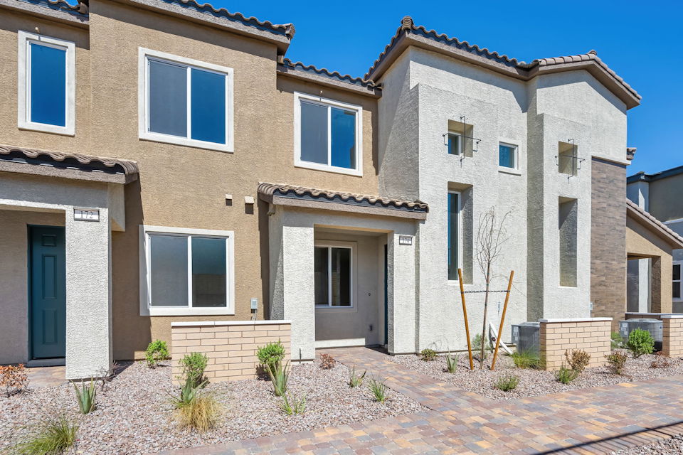 A house with a brick driveway.