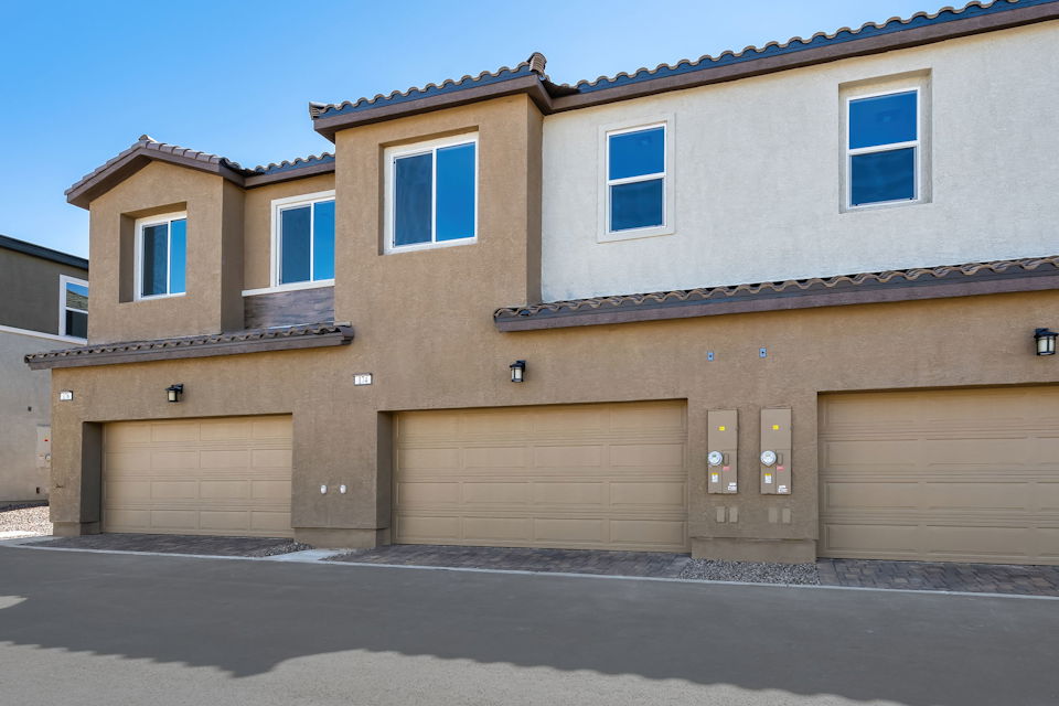 A building with garages and a blue sky.