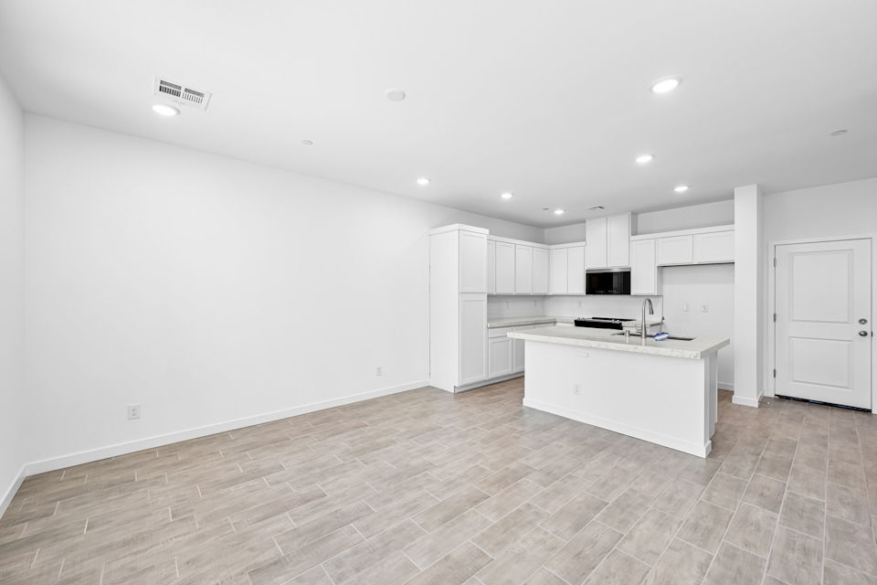 A kitchen with white cabinets.
