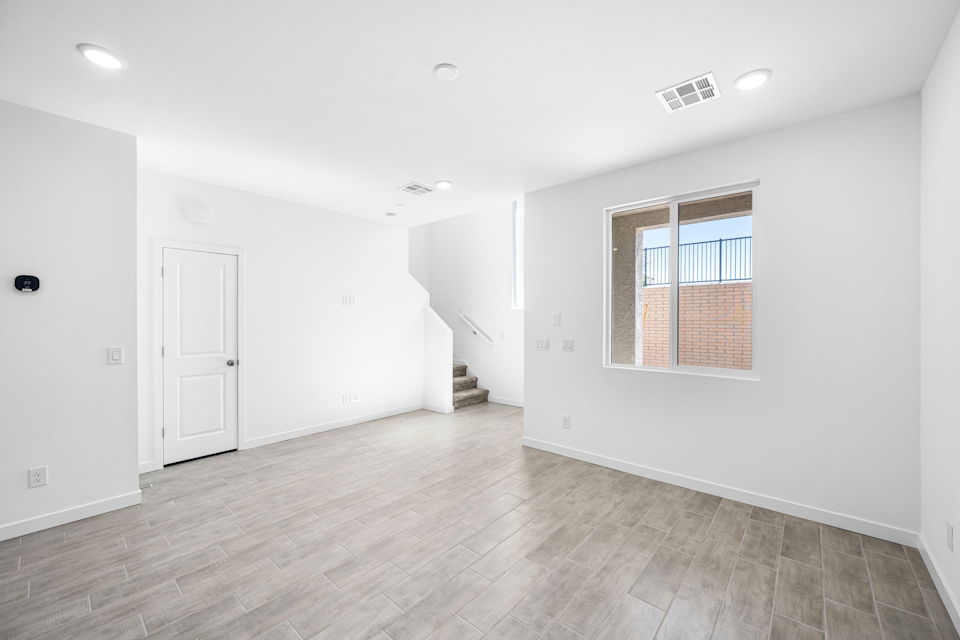 A room with a wood floor and a white door.