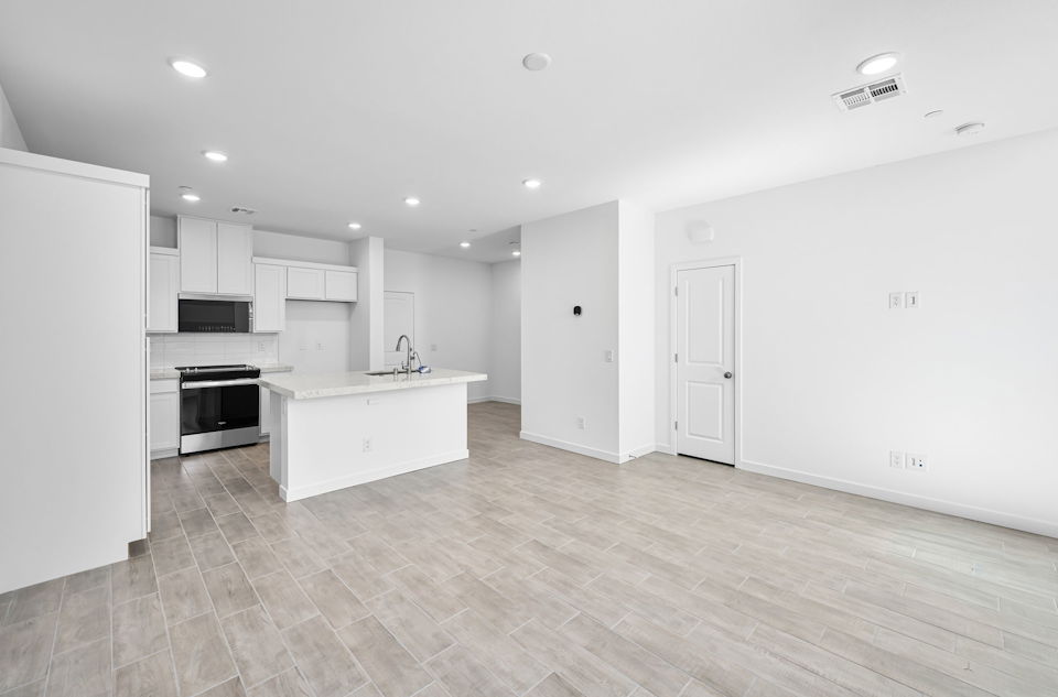 A kitchen with white cabinets.