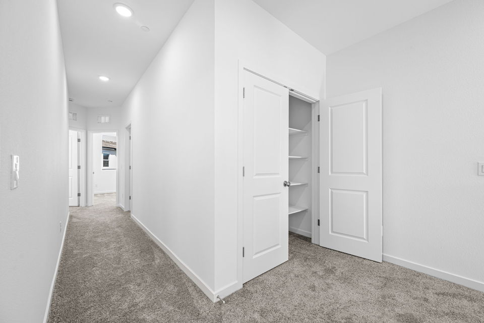 A hallway with white doors.