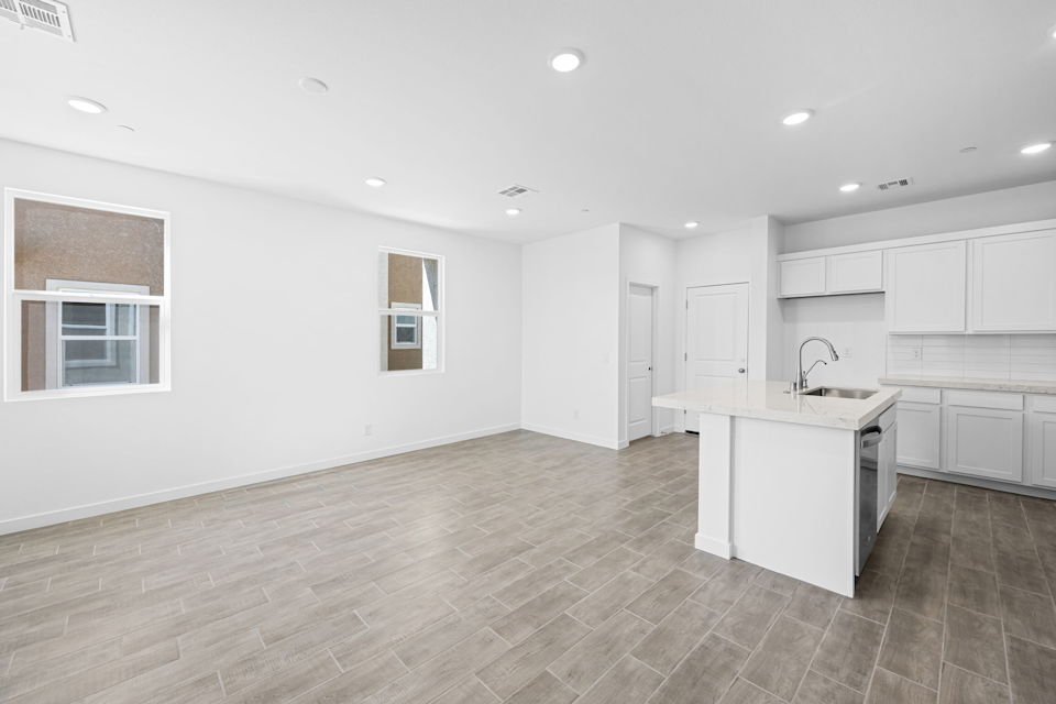 A kitchen with white cabinets.