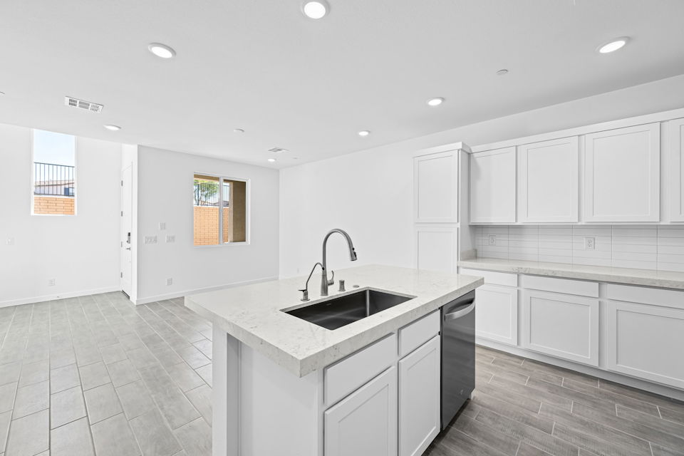 A kitchen with white cabinets.