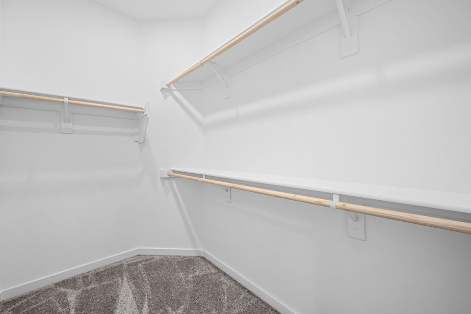 A white wall with a wooden pole.