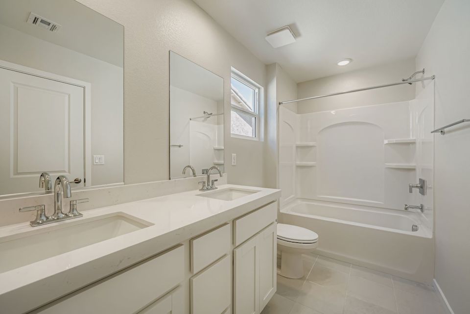 A bathroom with a tub sink and toilet.