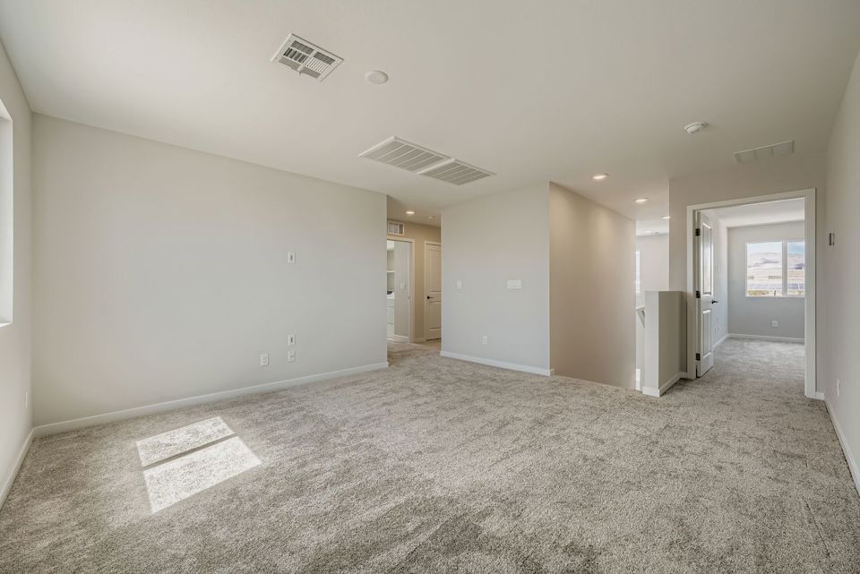 A long hallway with white doors.