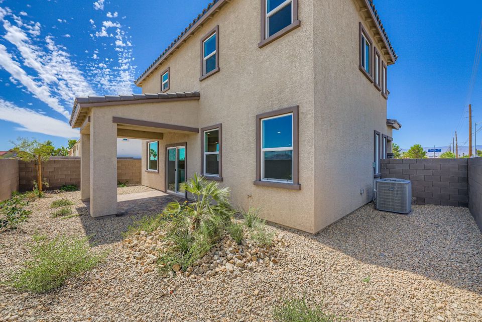 A house with a gravel driveway.