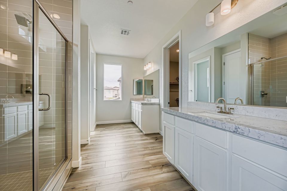 A bathroom with white cabinets.