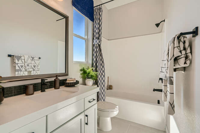 A bathroom with a tub toilet and sink.