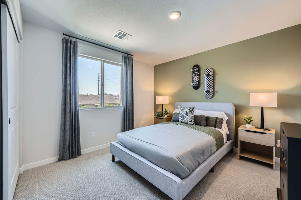 A bedroom with a bed and a window.
