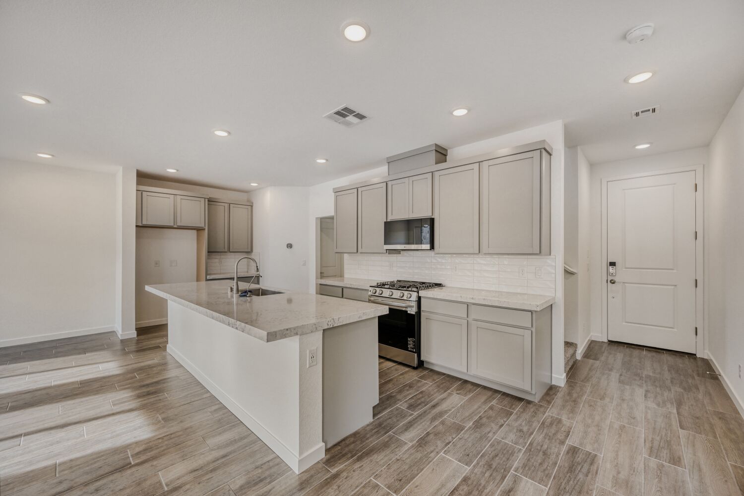 A kitchen with white cabinets.