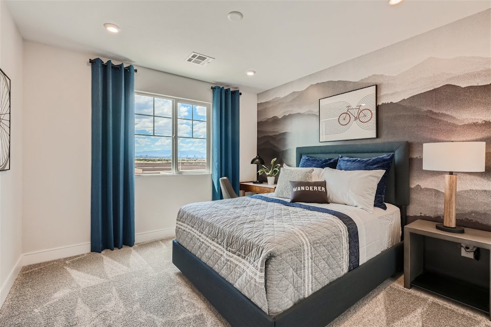 A bedroom with a bed and a window.