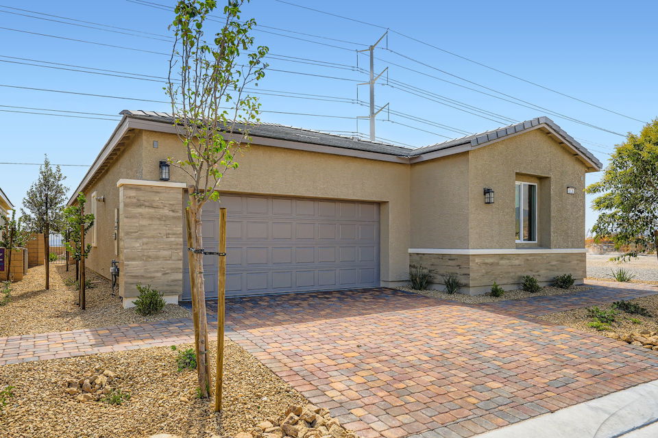 A house with a brick driveway.