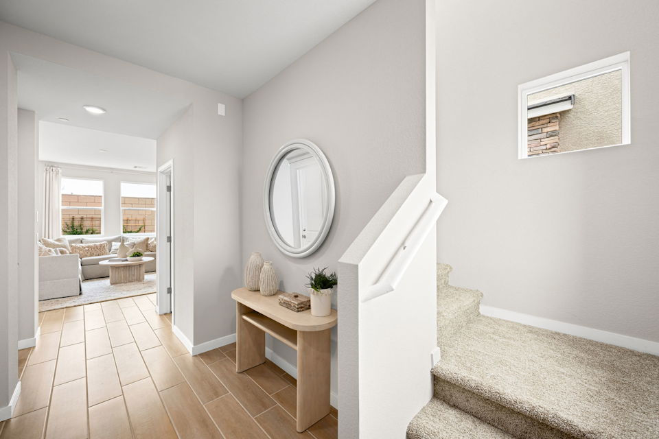 A room with a table and a mirror.