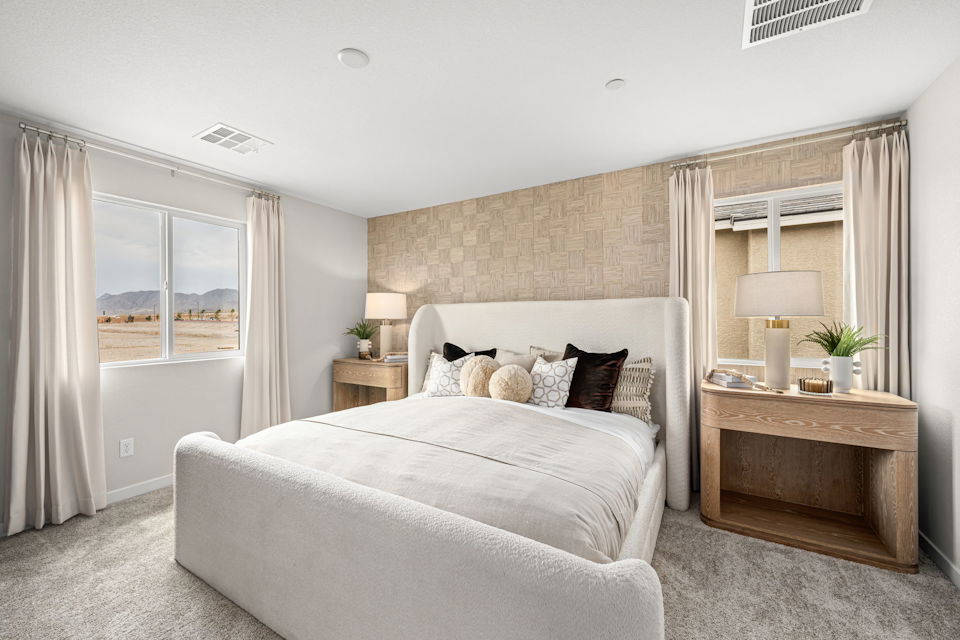 A bedroom with a bed and a table.