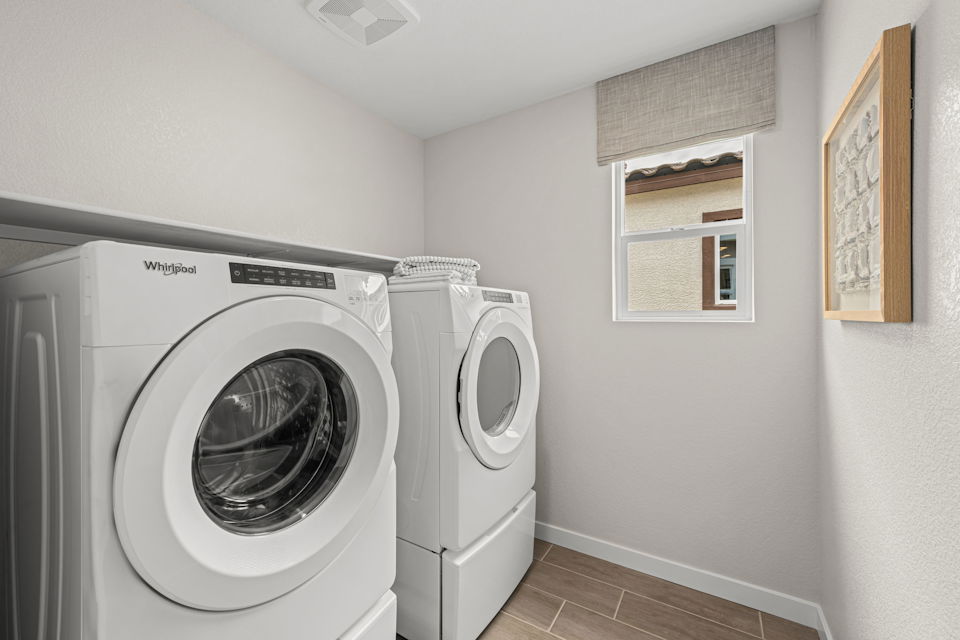 A washing machine in a room.