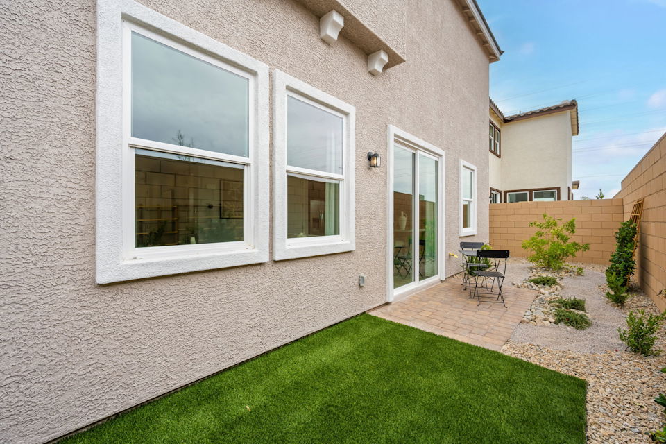 A house with a lawn and a chair in the front.