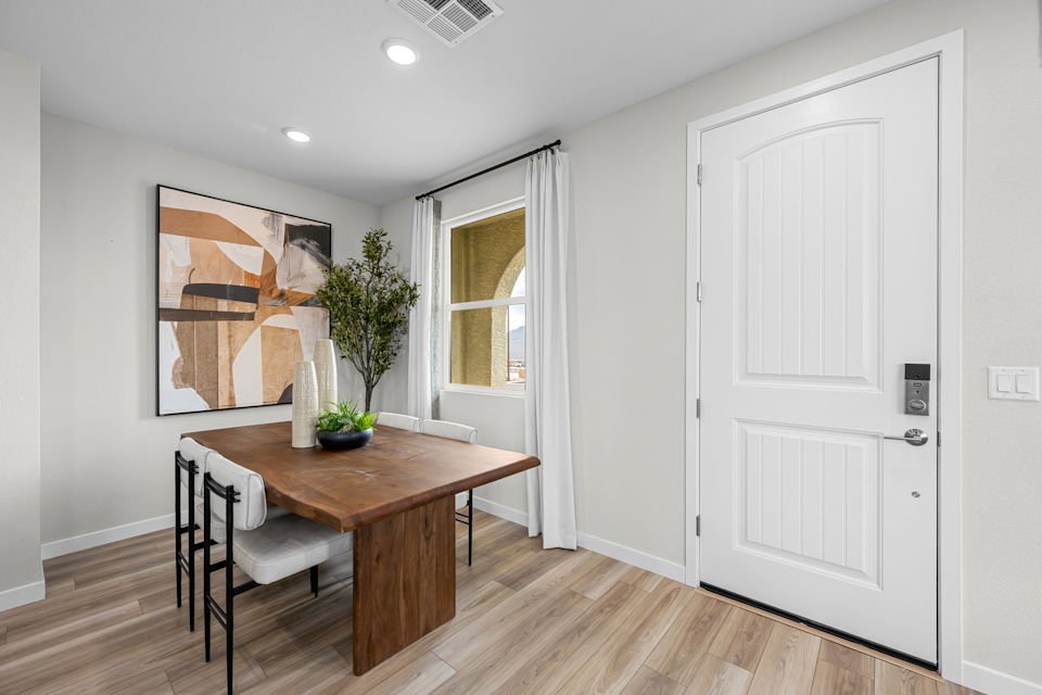 A room with a table and chairs.