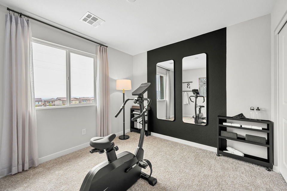 A room with a mirror and a chair.