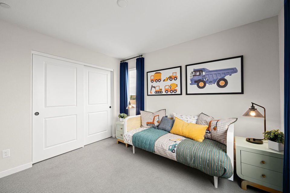 A bedroom with a bed and a dresser.