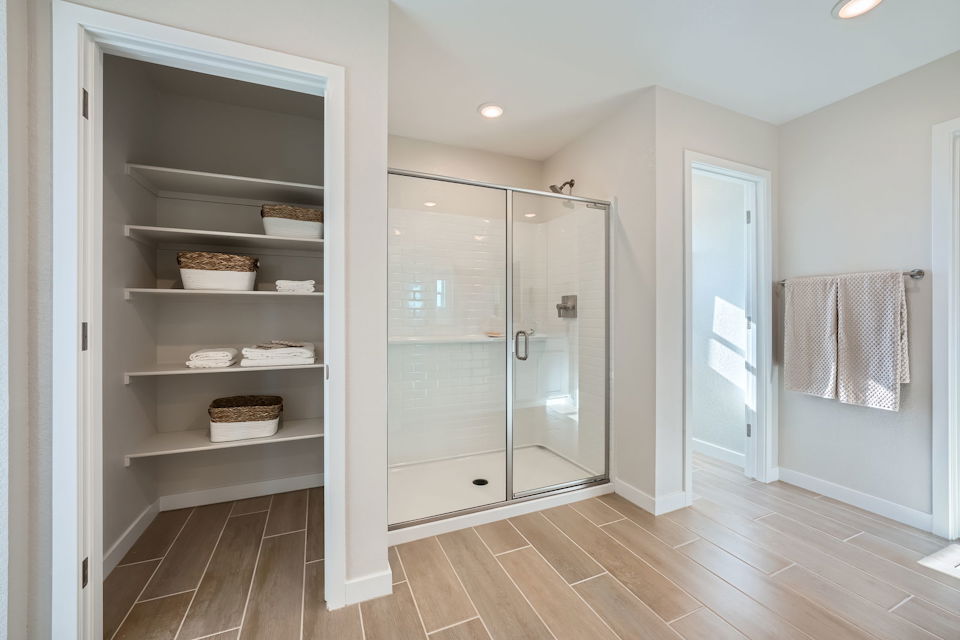 A room with a closet and a glass door.