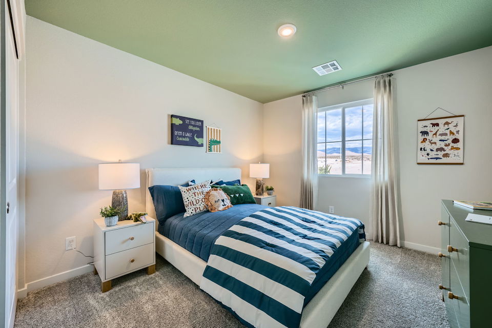 A bedroom with a bed and a window.