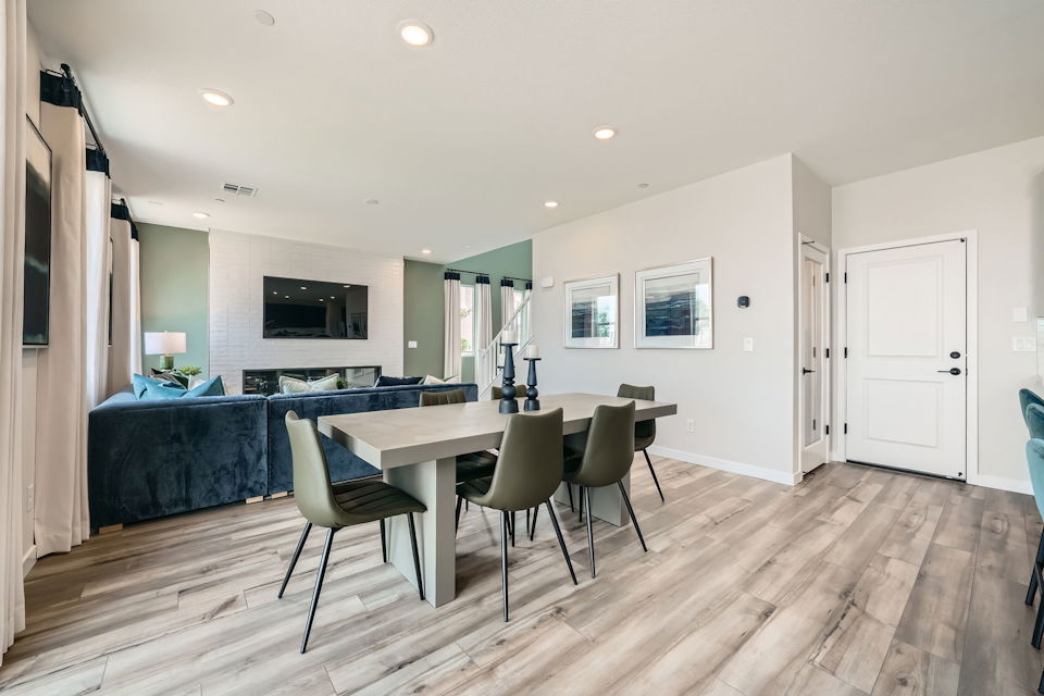 A dining room with a table and chairs.