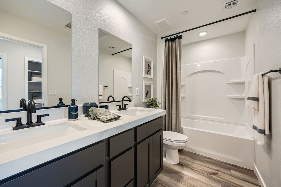 A bathroom with a tub sink and toilet.