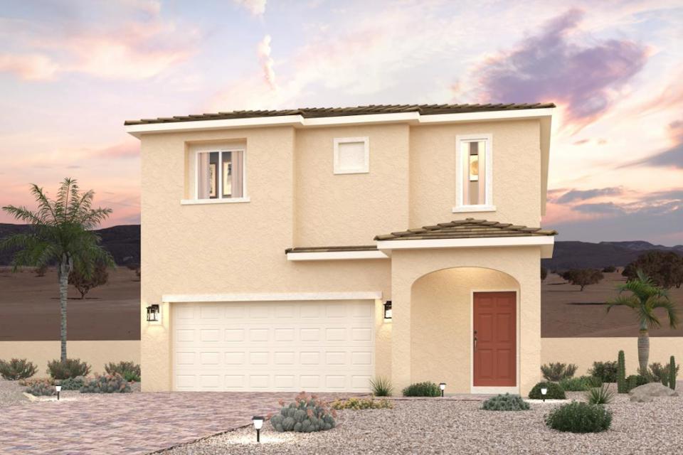 A house with a garage and palm trees.
