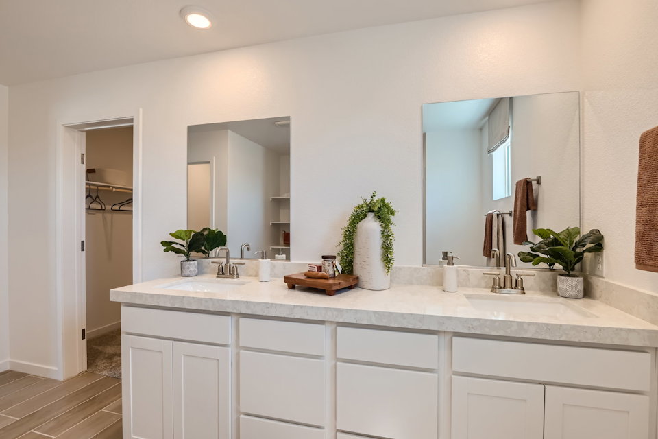 A bathroom with white cabinets.
