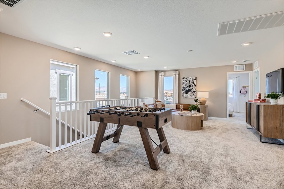 A large room with a table and chairs.