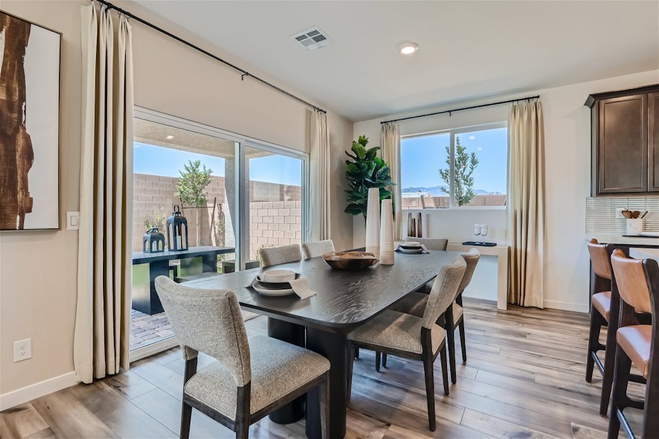A dining room table with chairs.
