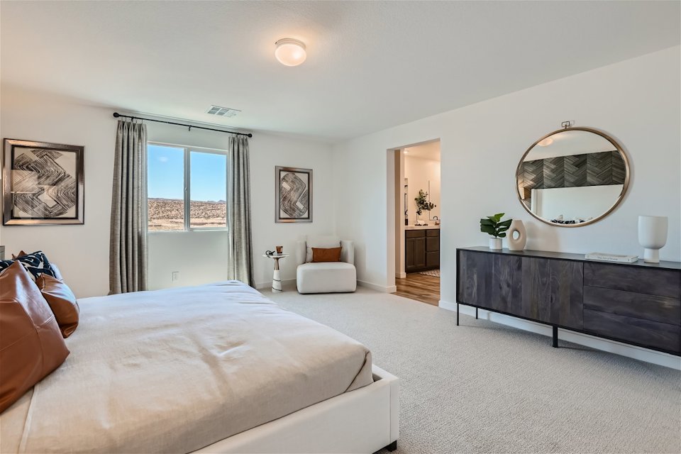 A bedroom with a large mirror.