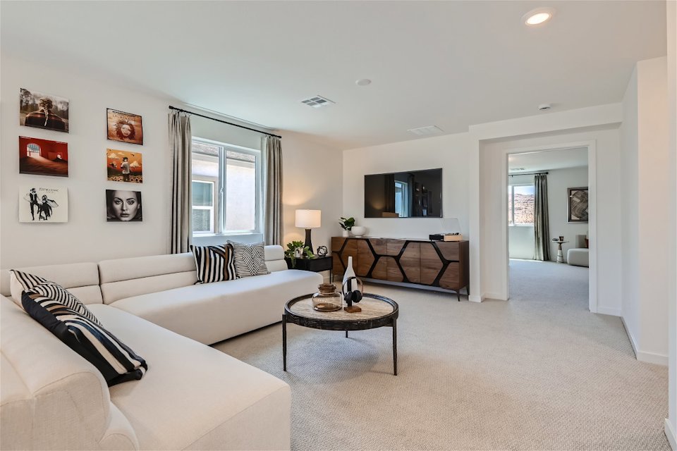 A living room with a couch and a table.