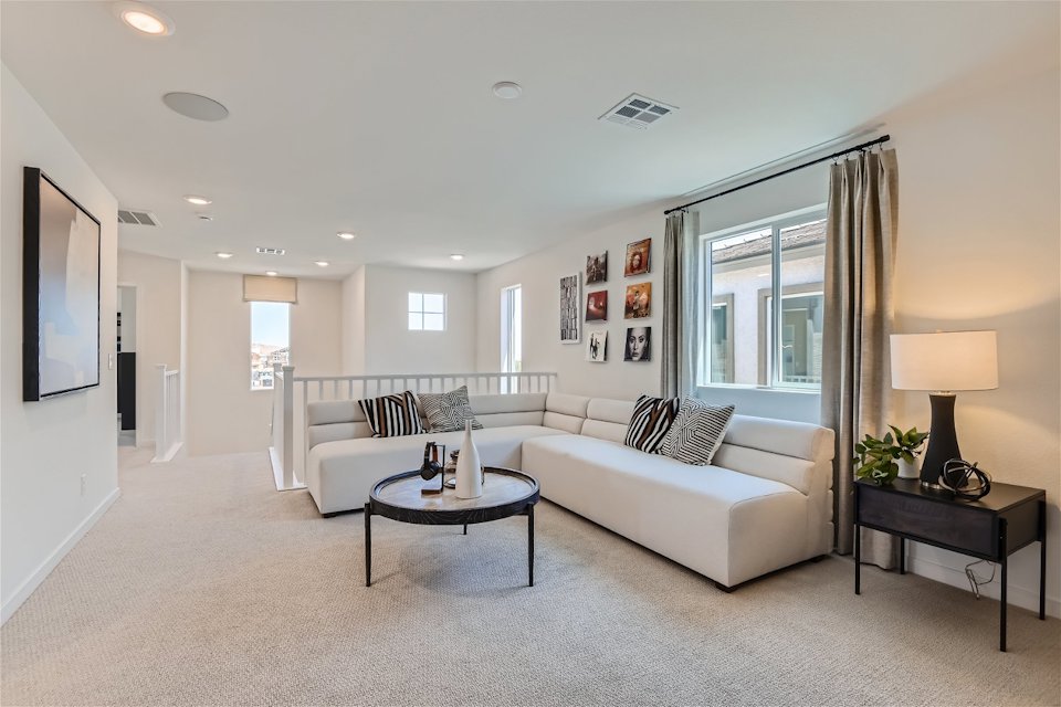 A living room with a white couch and a coffee table.