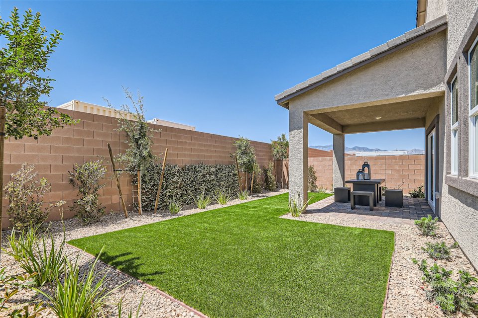A backyard with a brick wall and a brick wall.