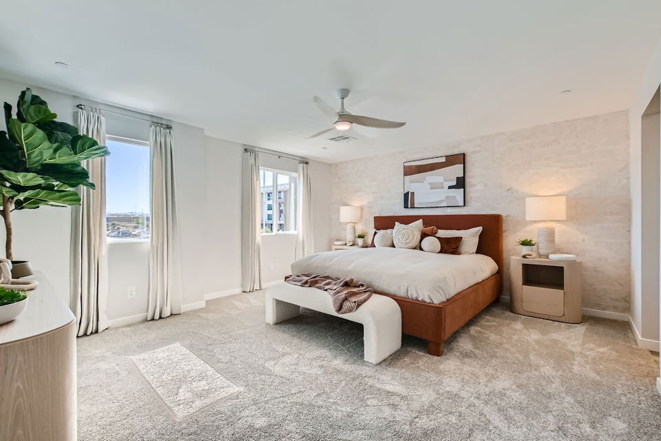 A bedroom with a bed and a bench.