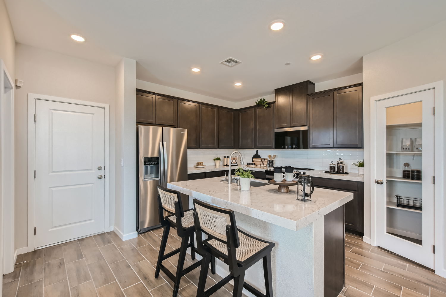 A kitchen with a marble island.