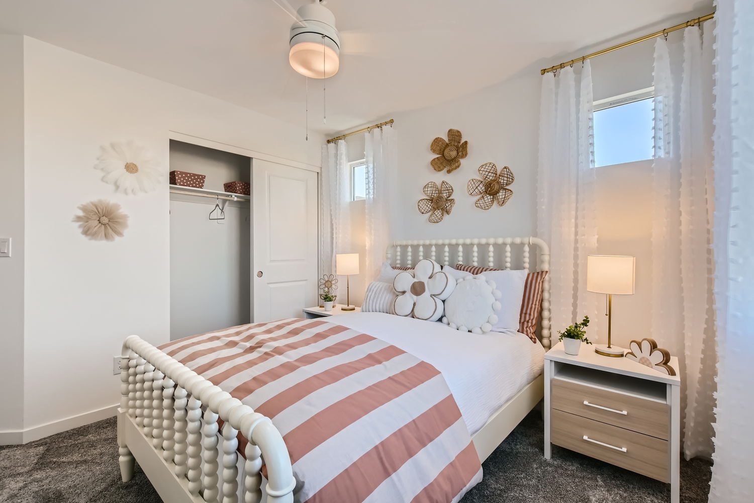 A bedroom with a bed and lamps.