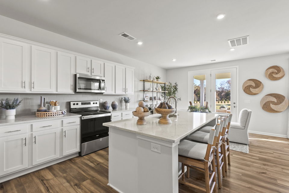 A kitchen with white cabinets.