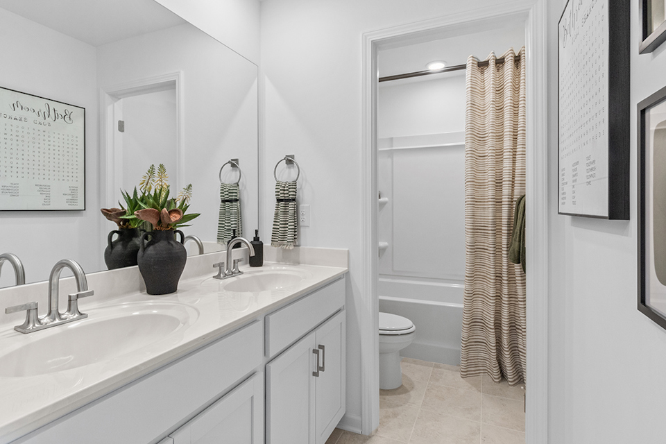 A bathroom with a shower and sink.